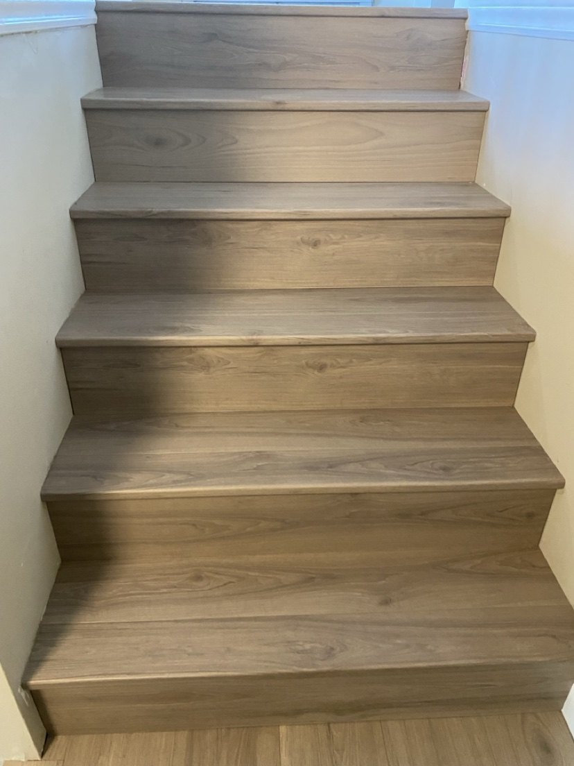 Finished wood staircase with tight seams installed by Hearth & Plank